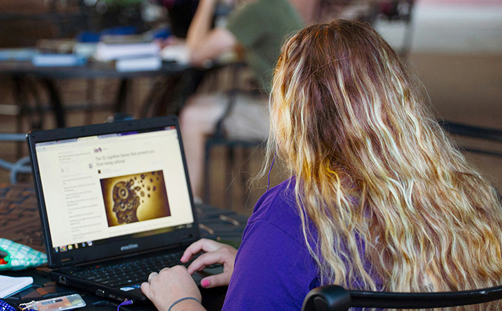 A student conducting research on a laptop.