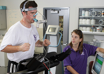A man jogging in place with a breath-monitoring apparatus
