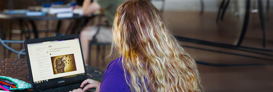 A student conducting research on a laptop.