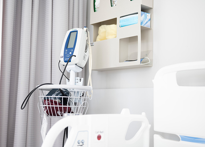 A closeup view of medical equipment next to a hospital bed.