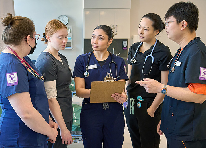 Nursing students discussing notes together.