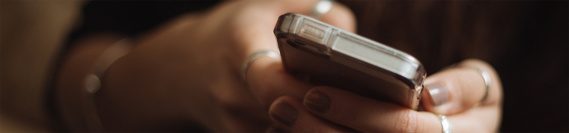 Hands holding a smartphone.