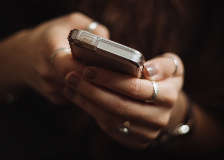 Hands holding a smartphone.