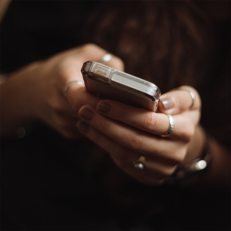 Hands holding a smartphone.