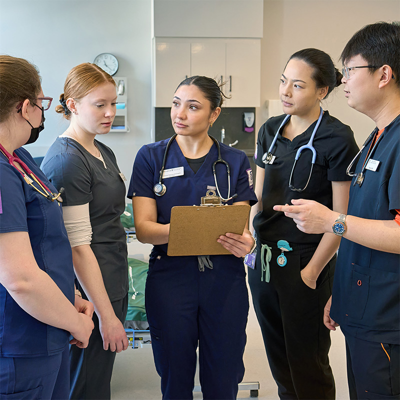 Nursing students discussing notes together.
