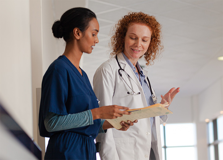 Two healthcare professionals reviewing information.