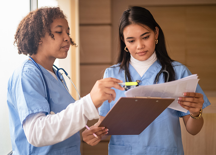 Two healthcare professionals reviewing documents.