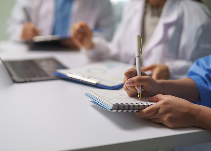 A healthcare professional taking notes.