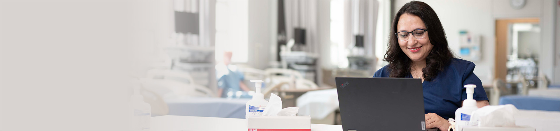 A nursing student working on their laptop.