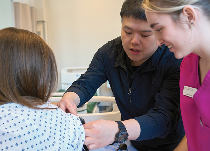A professor teaching a nursing student.