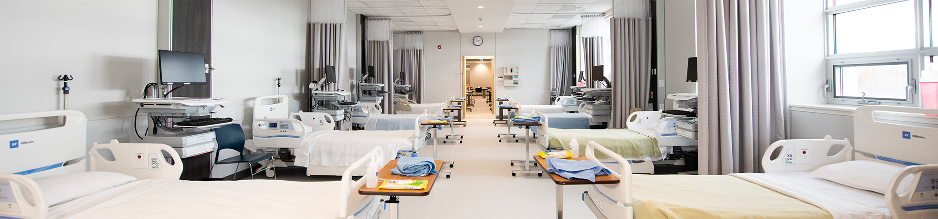 Rows of hospital beds in the clinical skills lab.