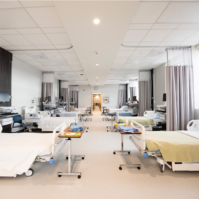 Rows of hospital beds in the clinical skills lab.