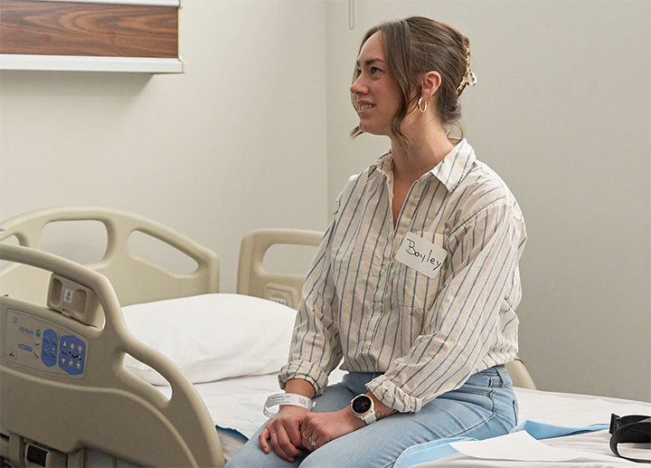A patient sitting on a hospital bed.