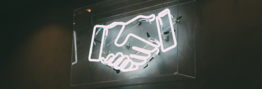 Neon sign of a handshake