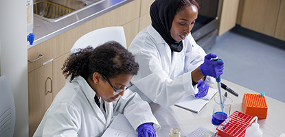 Two students working in lab together