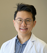 A headshot of Matthew Nguyen wearing a lab coat