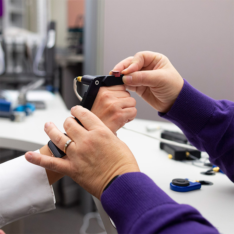 A hand therapist assisting a patient.