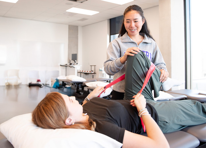 A Physical Therapy student teaching leg exercises.