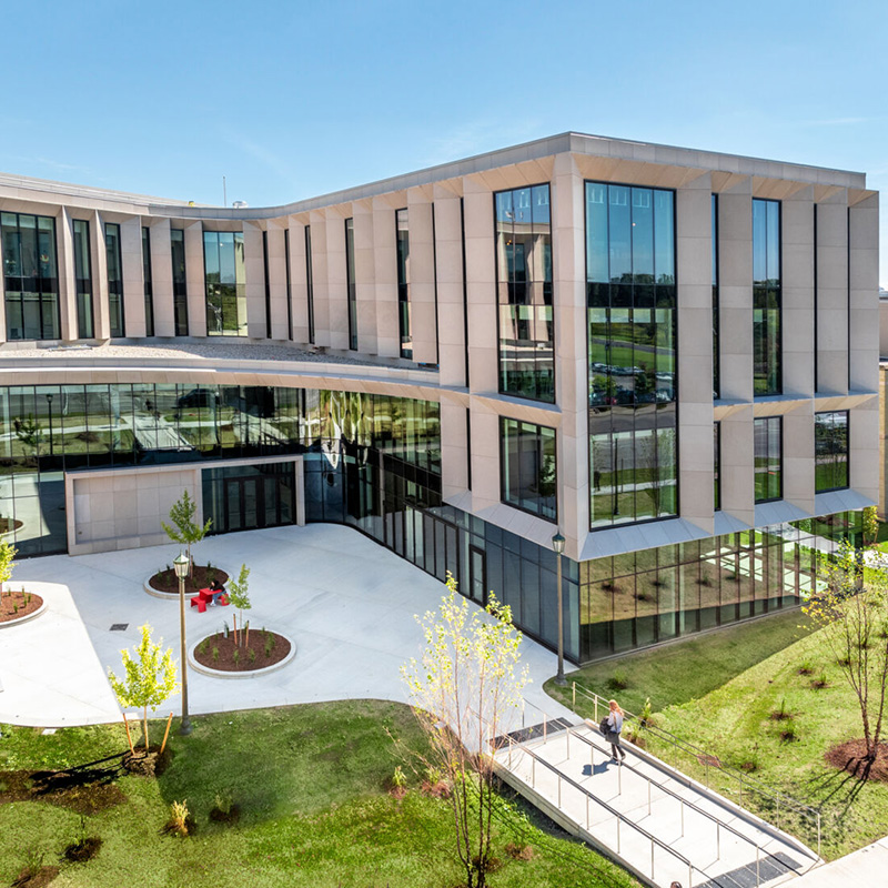 Exterior of the (Ronald D.) Schmeichel Entrepreneurship and Innovation Building (SEI) on a sunny day.