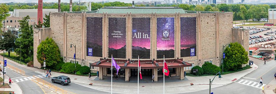 Alumni hall exterior with All In banners hanging from the facade