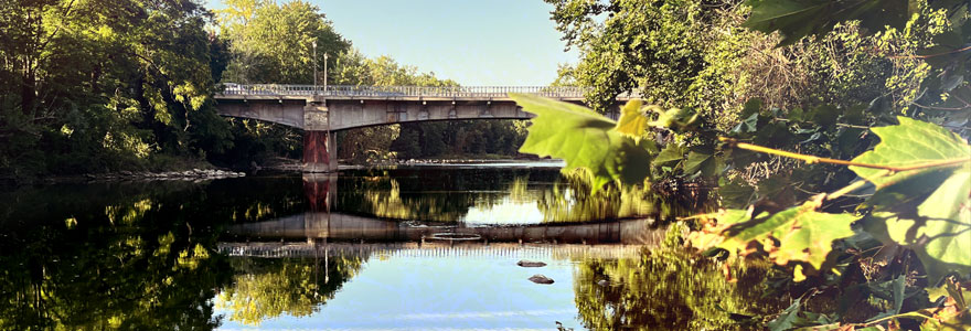 The Unversity Drive Bridge facing south with placid water of Deshkan Ziibi