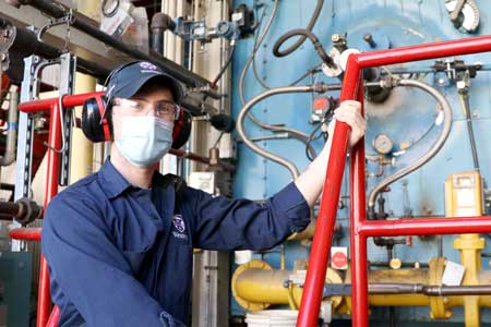 Liam standing in front of one of Western's boilers