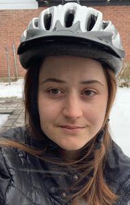 Chelsea with her helmet on outside in the snow