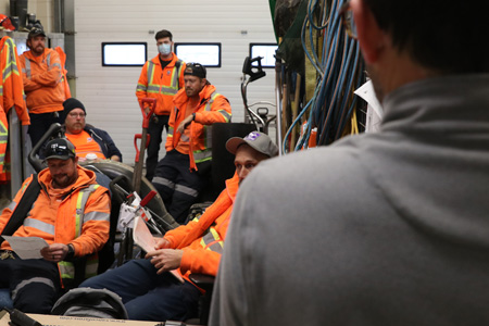 The entire team debriefs following the mock snow event