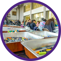 a group of students drawing at a table
