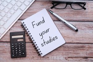 Fund your studies written on notebook