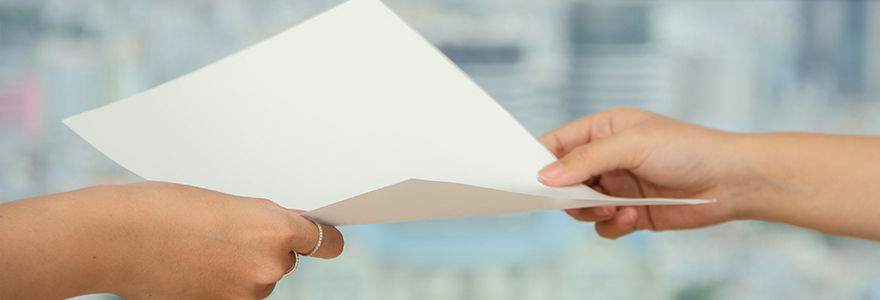 Imagine of two hands passing a piece of paper.