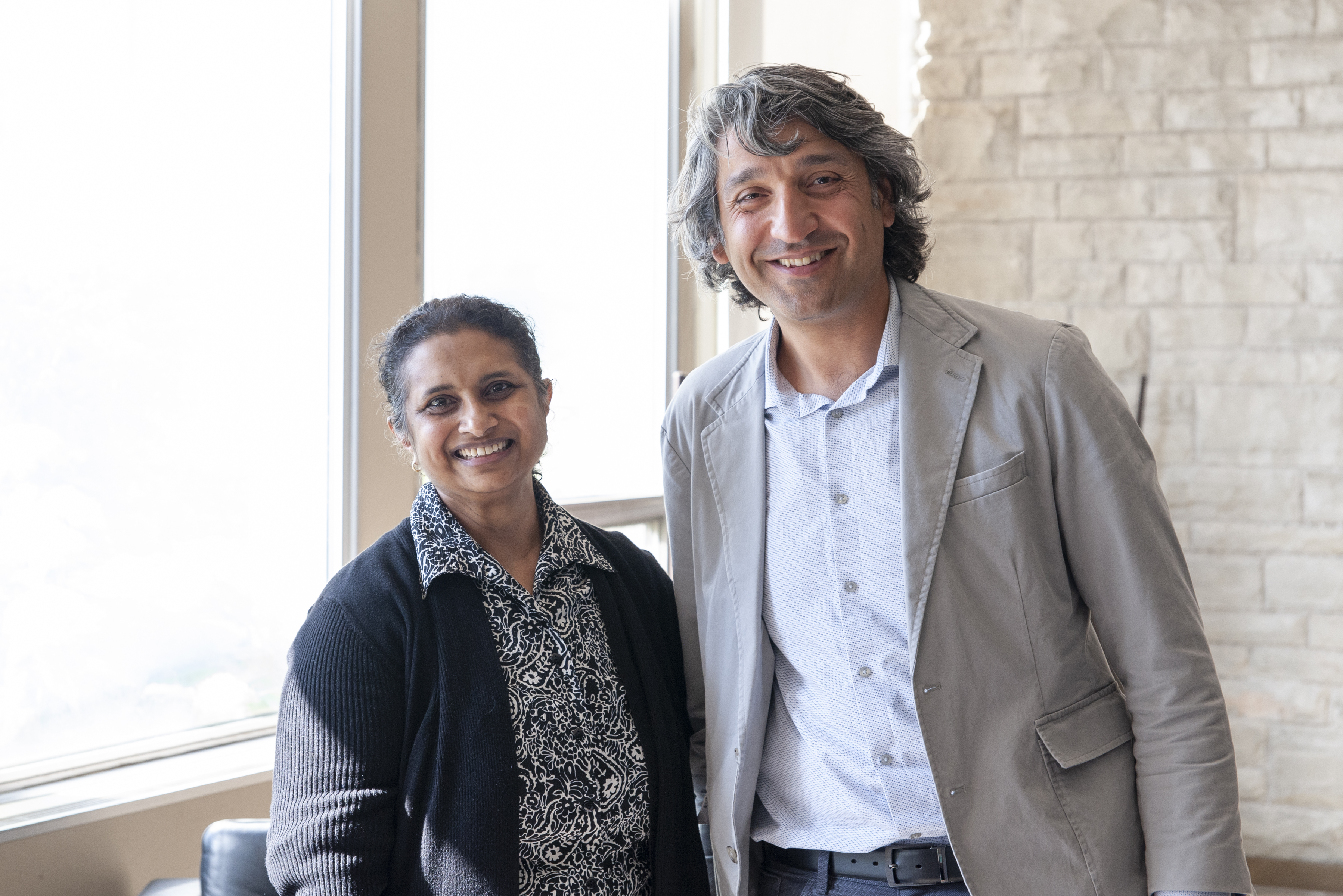 Two people standing together at a symposium