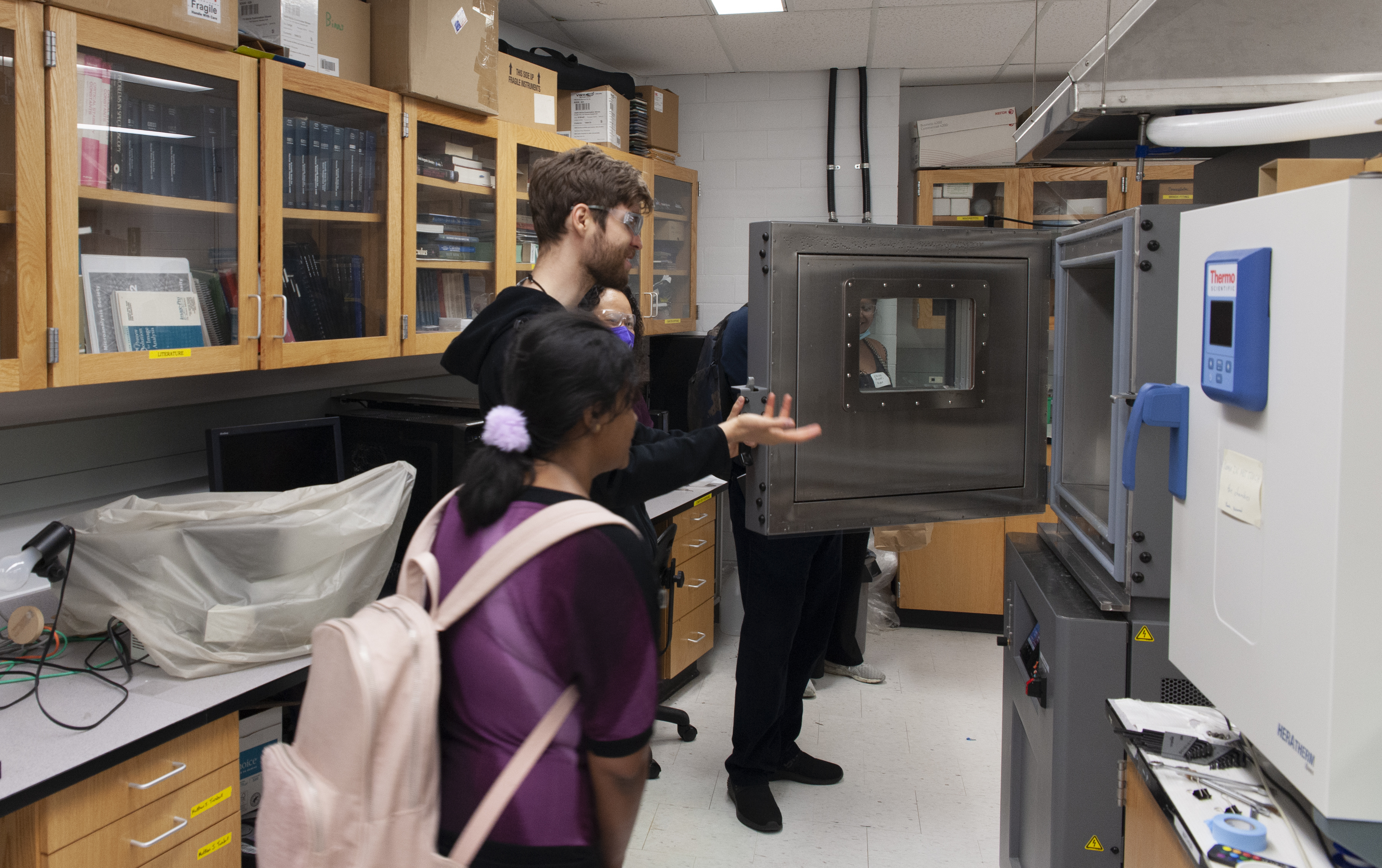 Young people exploring a lab instrument