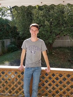 Matthew McCready outside leaning on a fence