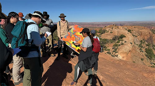 Students consult a topographic map in Canyonlands National Park in Utah