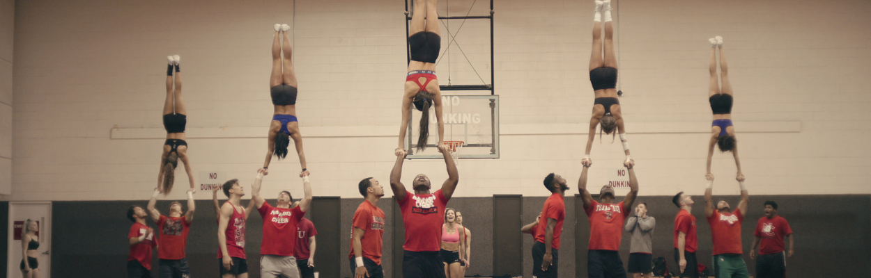 a screenshot from the series cheer, of cheerleaders practicing a routine