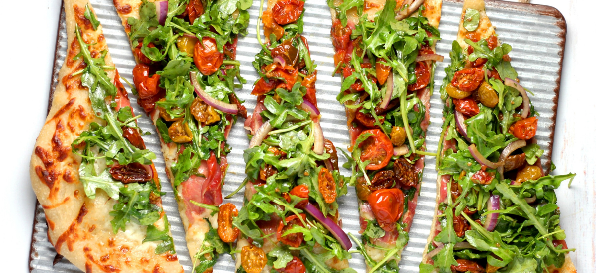 A sliced vegetable pizza on a plate