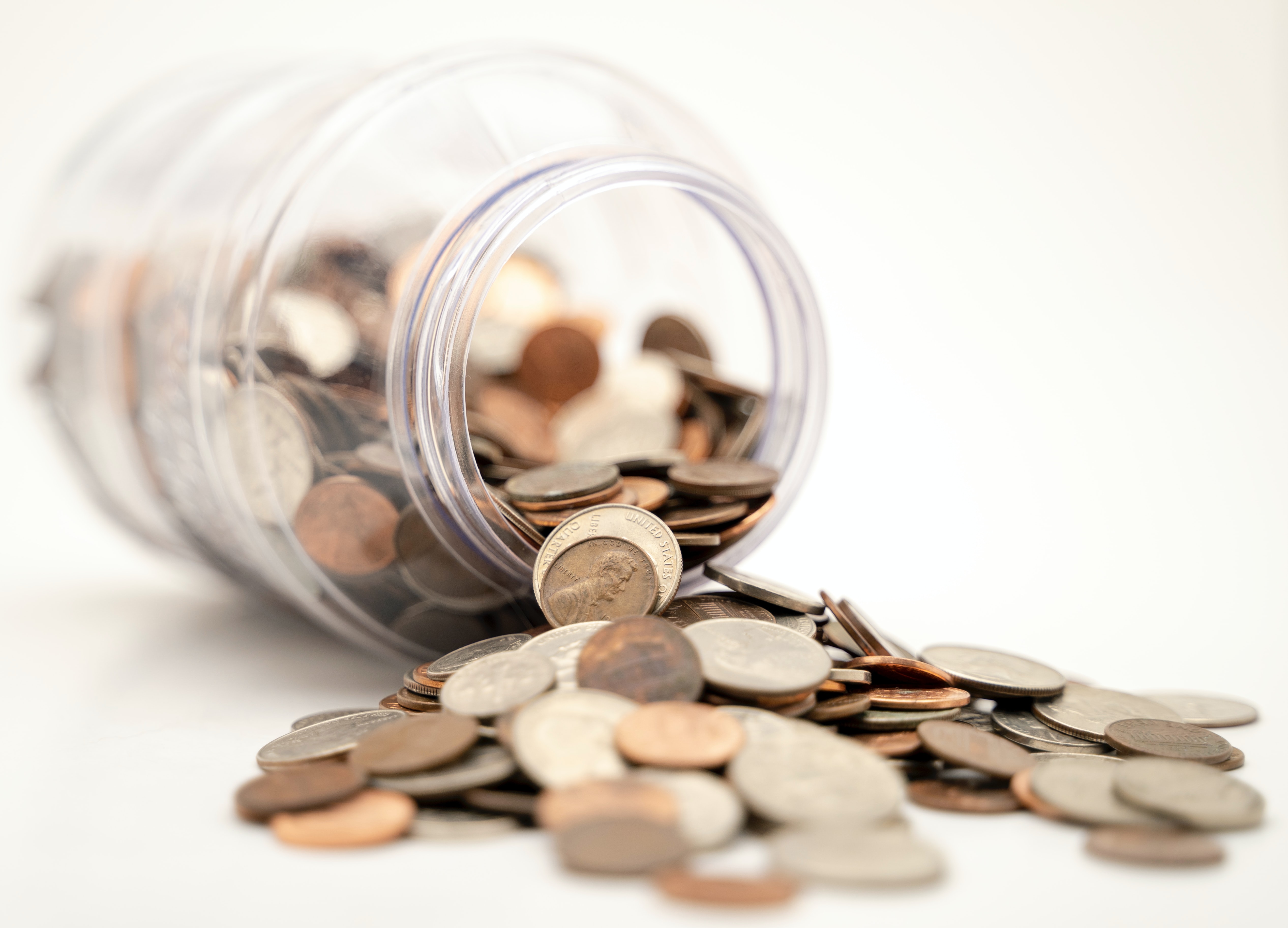 Coins spilling out of a jar