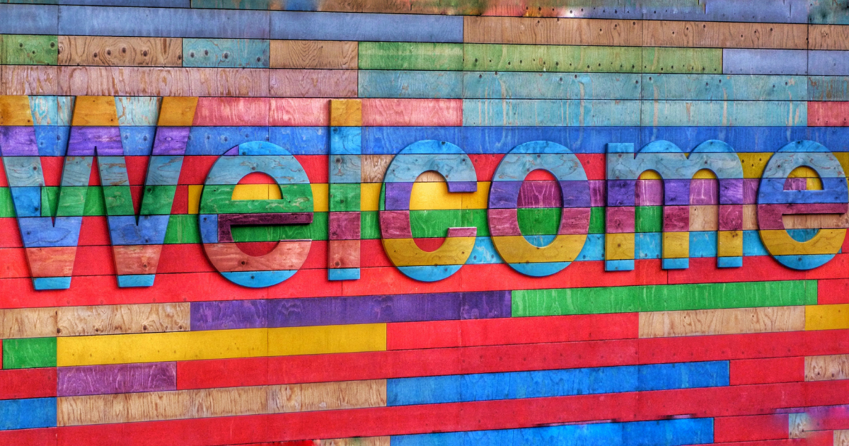 A bright neon and colourful sign that says "Welcoome"