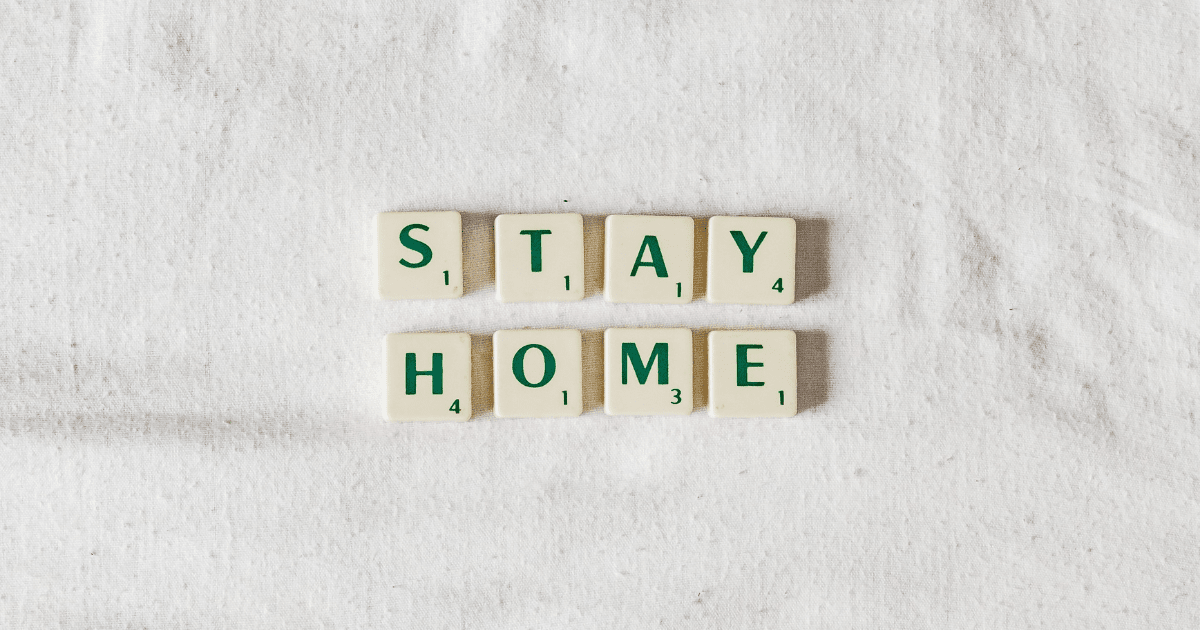 Scrabble tiles on a white background spelling out "Stay home"
