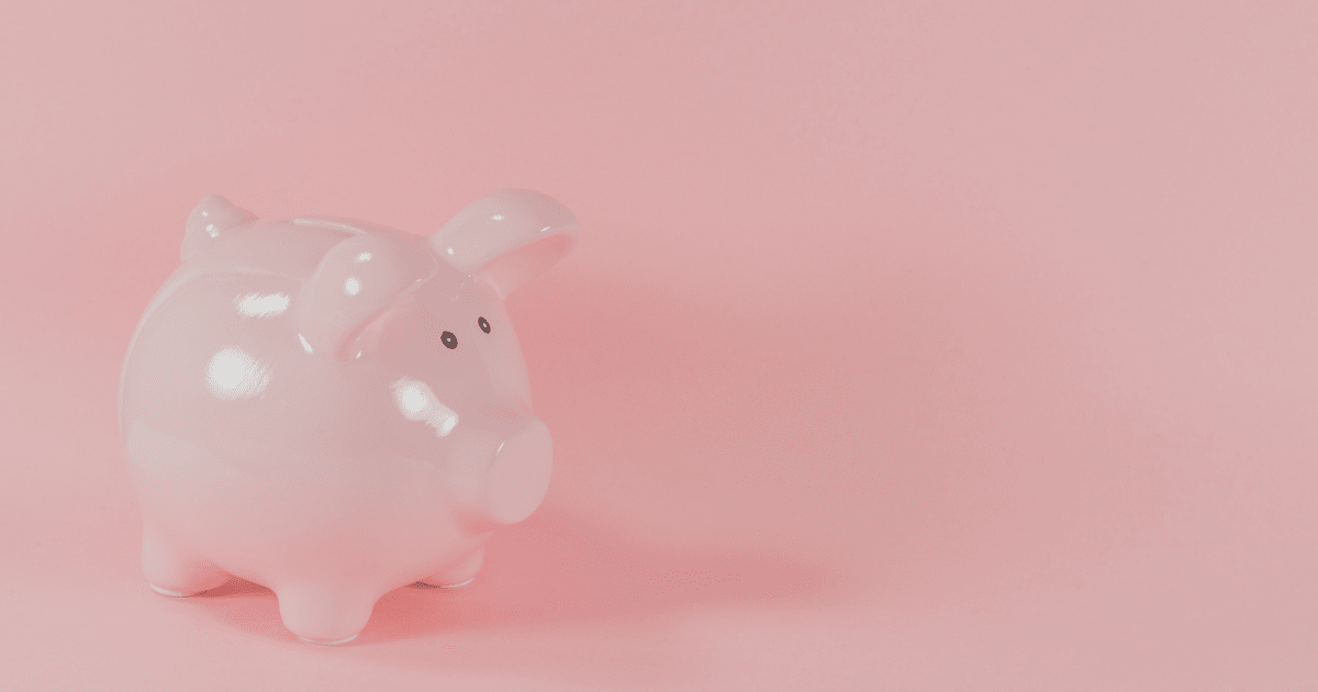 A pink piggy bank sitting against a pink background