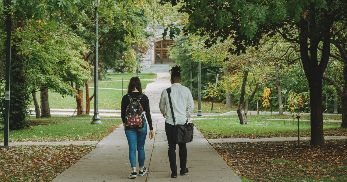 Two students walking together on campus towards Middlesex College