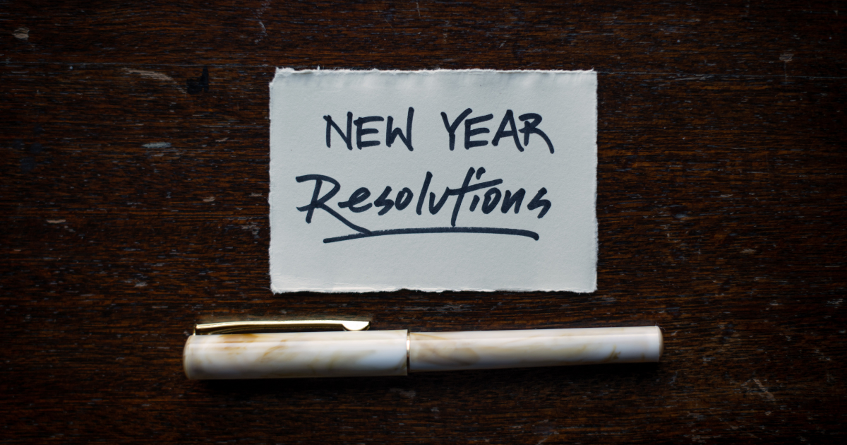 A piece of white paper with the phrase New Years Resolutions on it