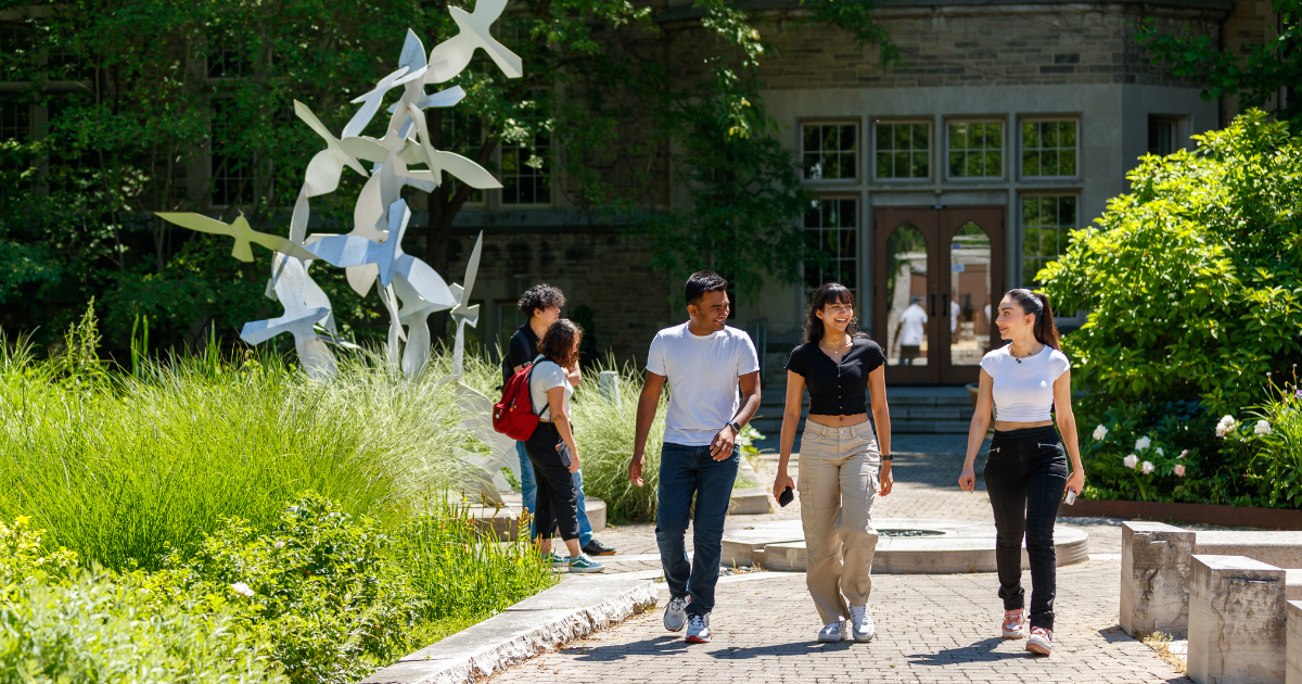 students walking on a path on campus.