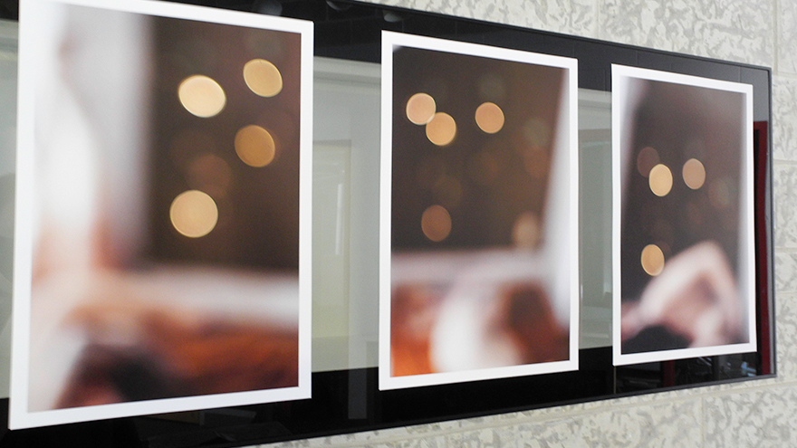 A view of four photographs of refracted, colourful light in warm tones